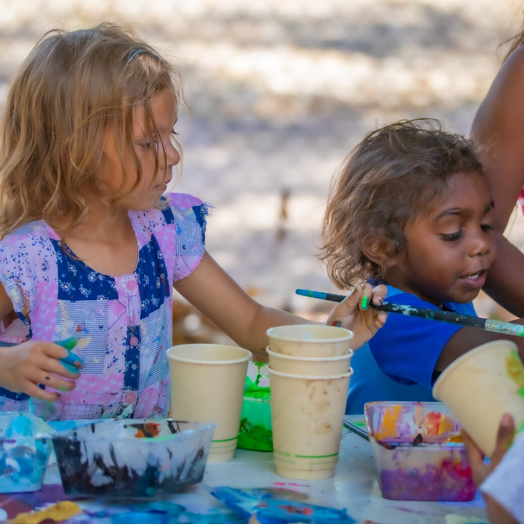Two kids at a youth program doing fun activities.